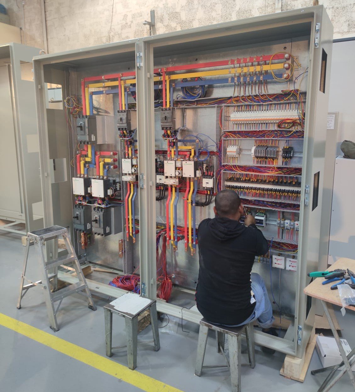 AWTC technician commissioning a control panel on site
